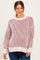 woman wearing a striped maternity sweater in cream and burgundy with balloon sleeves and a relaxed fit