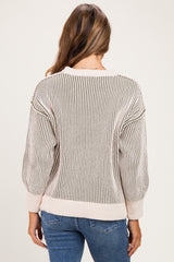 woman wearing a striped maternity sweater with oversized sleeves, shown from the back
