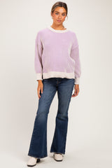 woman wearing a lavender striped maternity sweater and flared jeans, with a relaxed fit and long sleeves