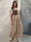 woman wearing a brown striped maxi dress with a fitted bodice and flowy skirt, styled with a white t-shirt underneath