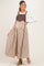 woman wearing a brown and white striped maternity maxi dress with a fitted bodice and loose skirt, showing off her baby bump