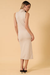 woman wearing a beige sleeveless midi dress with a high neckline and a fitted silhouette