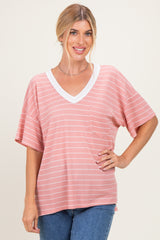 woman wearing a pink and white striped short sleeve v-neck top with a front pocket and relaxed fit