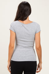 woman wearing a gray short sleeve fitted top, view from the back, showing a smooth silhouette