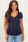 woman wearing a navy blue short sleeve maternity top with a v-neck and button details