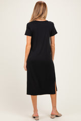 woman wearing a black short sleeve maternity maxi dress with a side slit, shown from the back