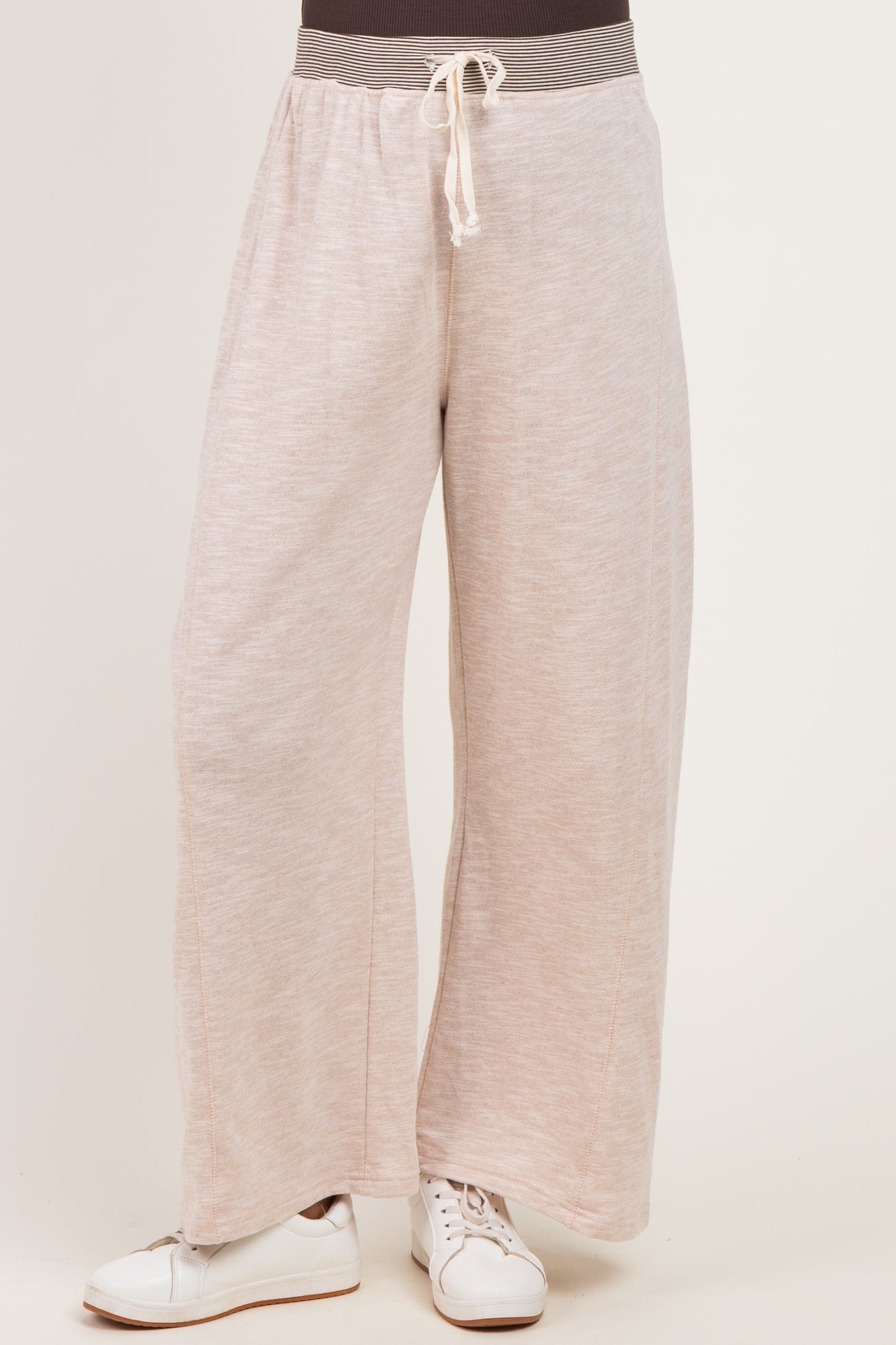 woman wearing light pink wide-leg maternity pants with drawstring waist