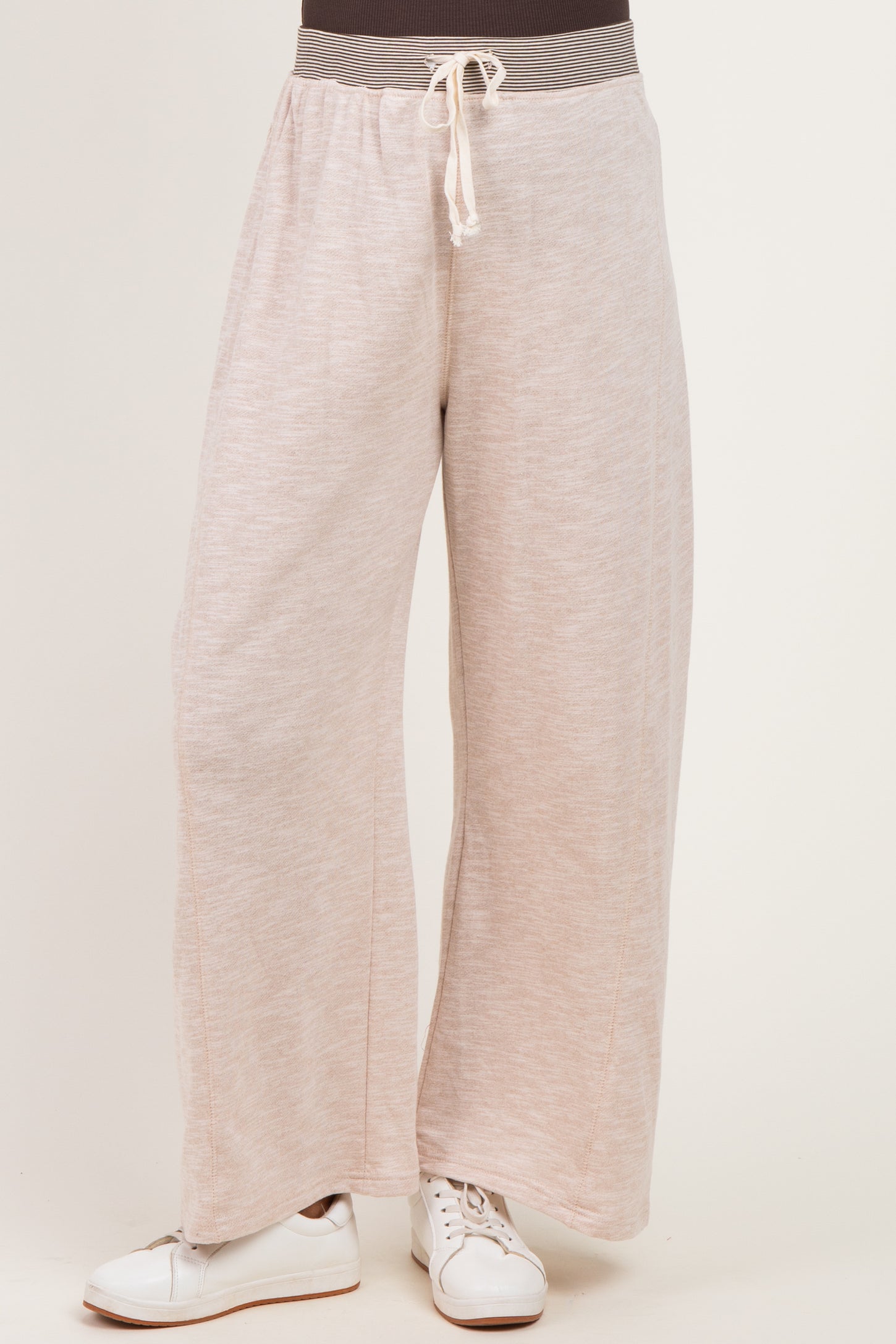 woman wearing light pink wide-leg maternity pants with drawstring waist