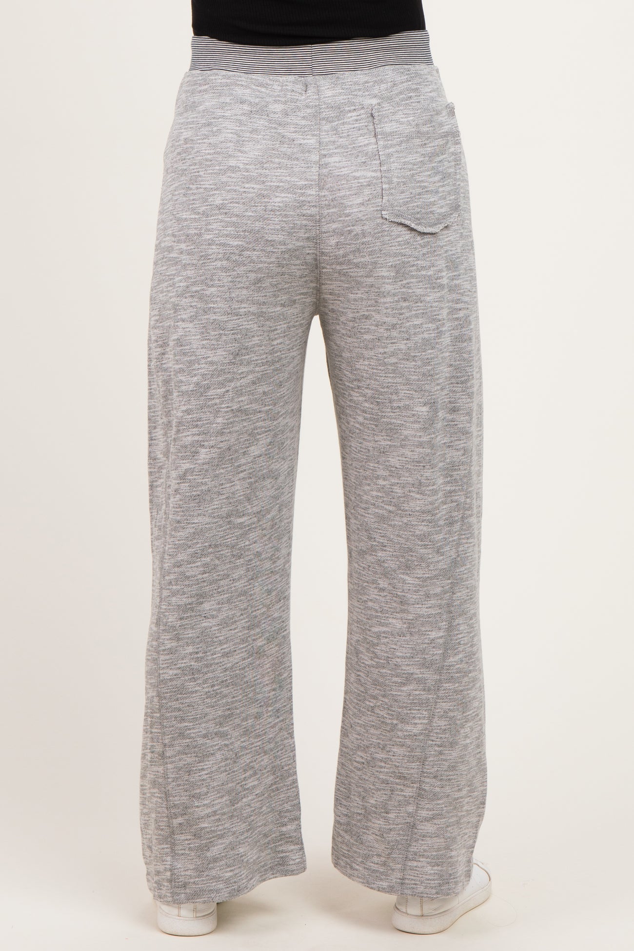 woman wearing light gray maternity wide-leg pants, showing the back view with a single pocket