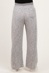woman wearing light gray maternity wide-leg pants, showing the back view with a single pocket