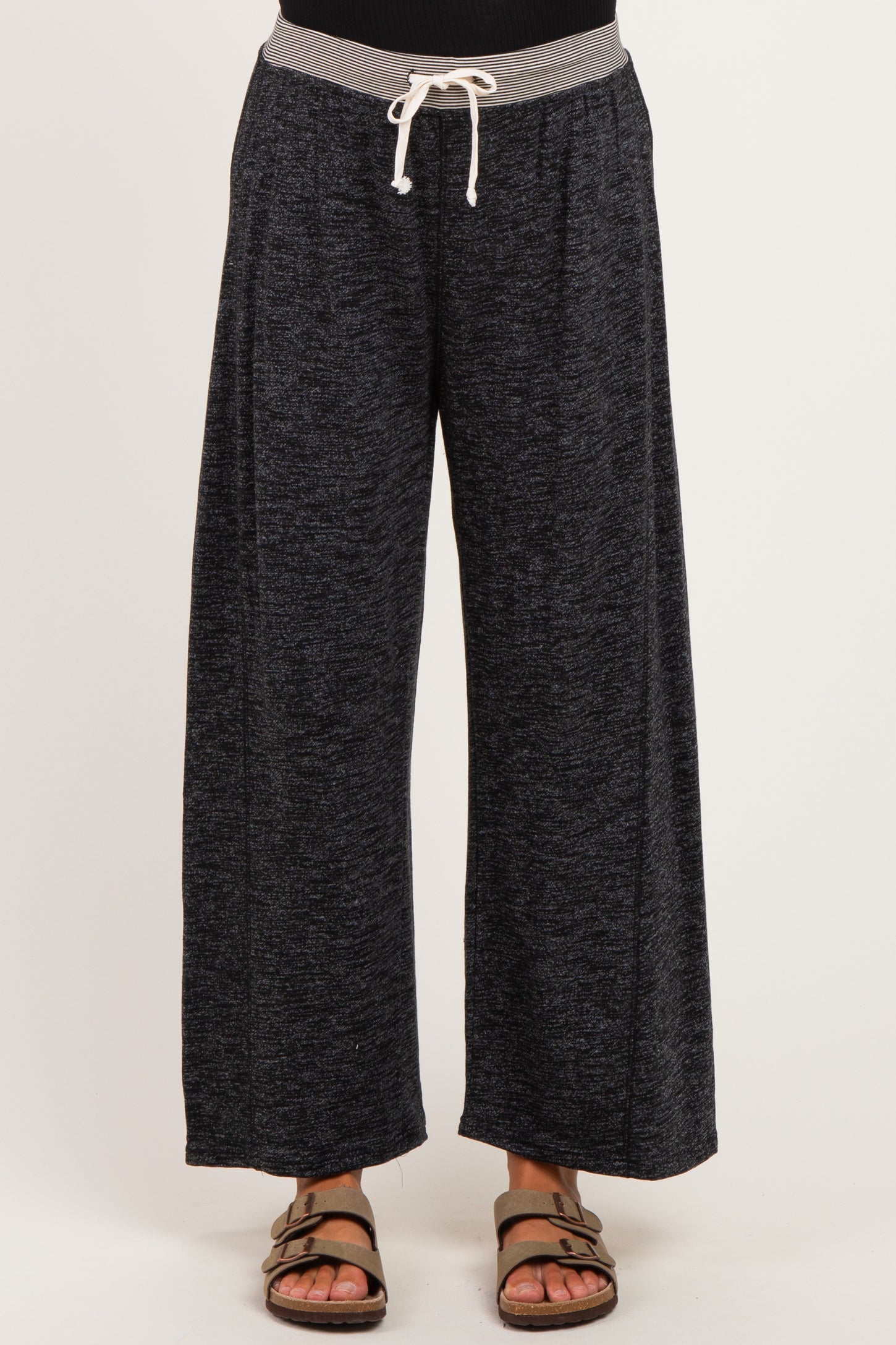 woman wearing comfortable black wide-leg maternity pants with a grey drawstring waistband