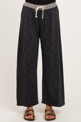 woman wearing comfortable black wide-leg maternity pants with a grey drawstring waistband