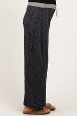 woman wearing dark gray maternity lounge pants with a drawstring waist, showing her baby bump on the side