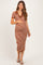woman wearing a rust and cream striped maternity dress with a v-neck and short sleeves, holding her baby bump