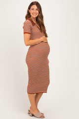 woman wearing a rust and cream striped maternity dress, highlighting her baby bump with a fitted silhouette