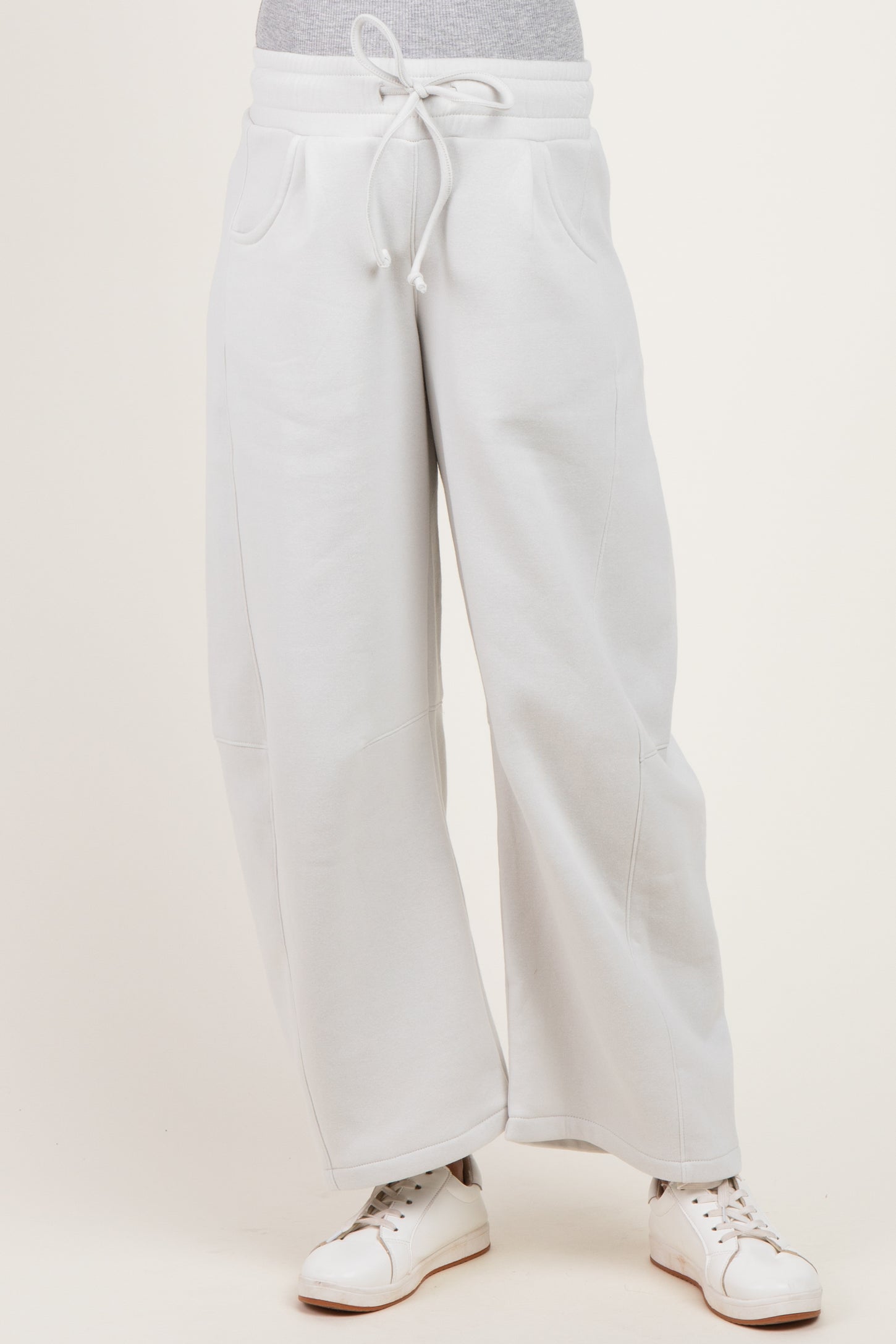 woman wearing light gray wide-leg maternity sweatpants with an elastic waistband and side pockets