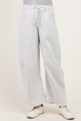 woman wearing light gray wide-leg maternity sweatpants with an elastic waistband and side pockets