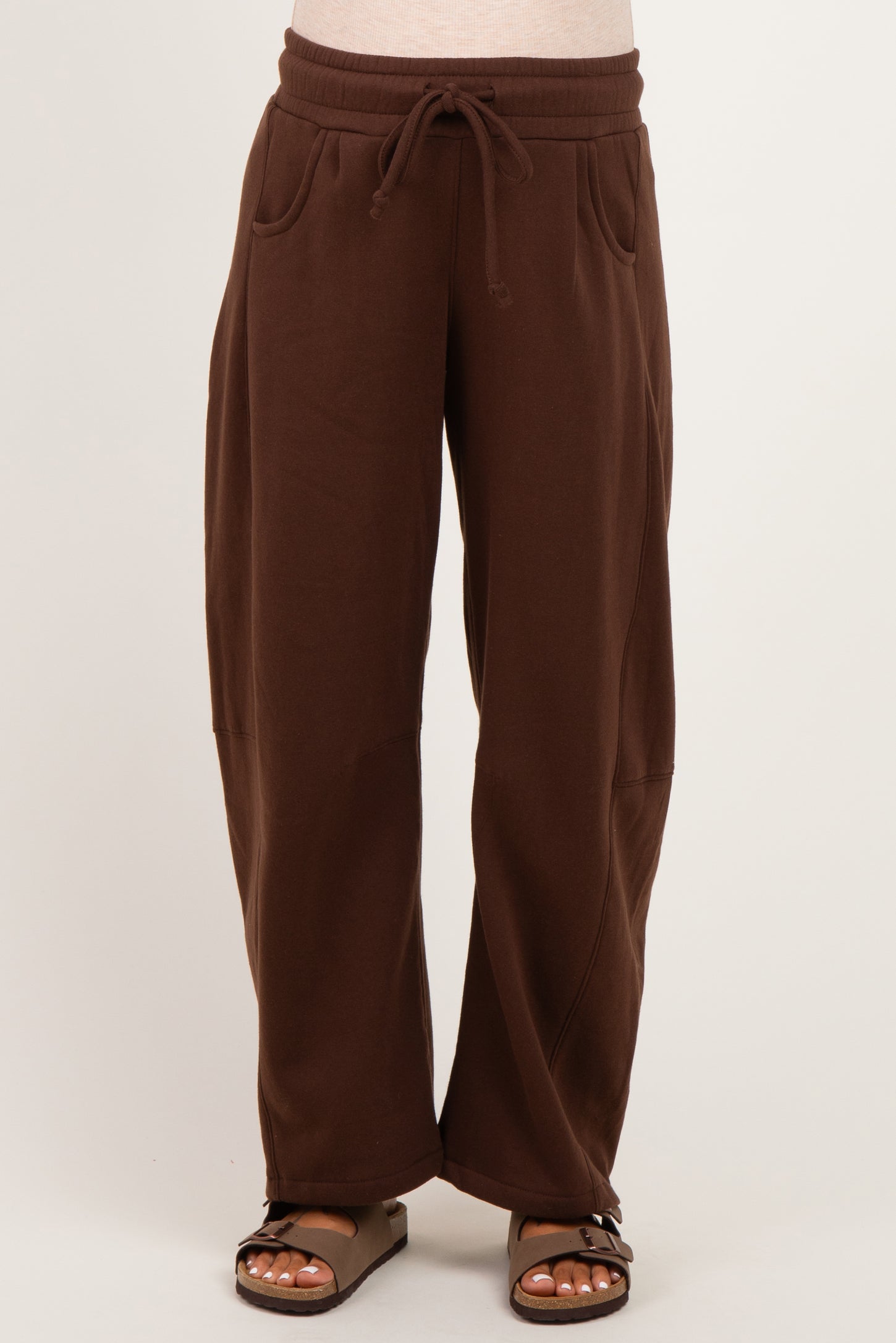 woman wearing brown maternity wide-leg sweatpants with drawstring waist and side pockets