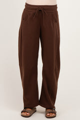 woman wearing brown maternity wide-leg sweatpants with drawstring waist and side pockets
