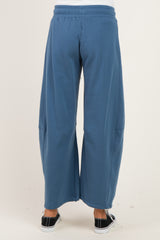 woman wearing blue wide-leg maternity sweatpants, shown from the back