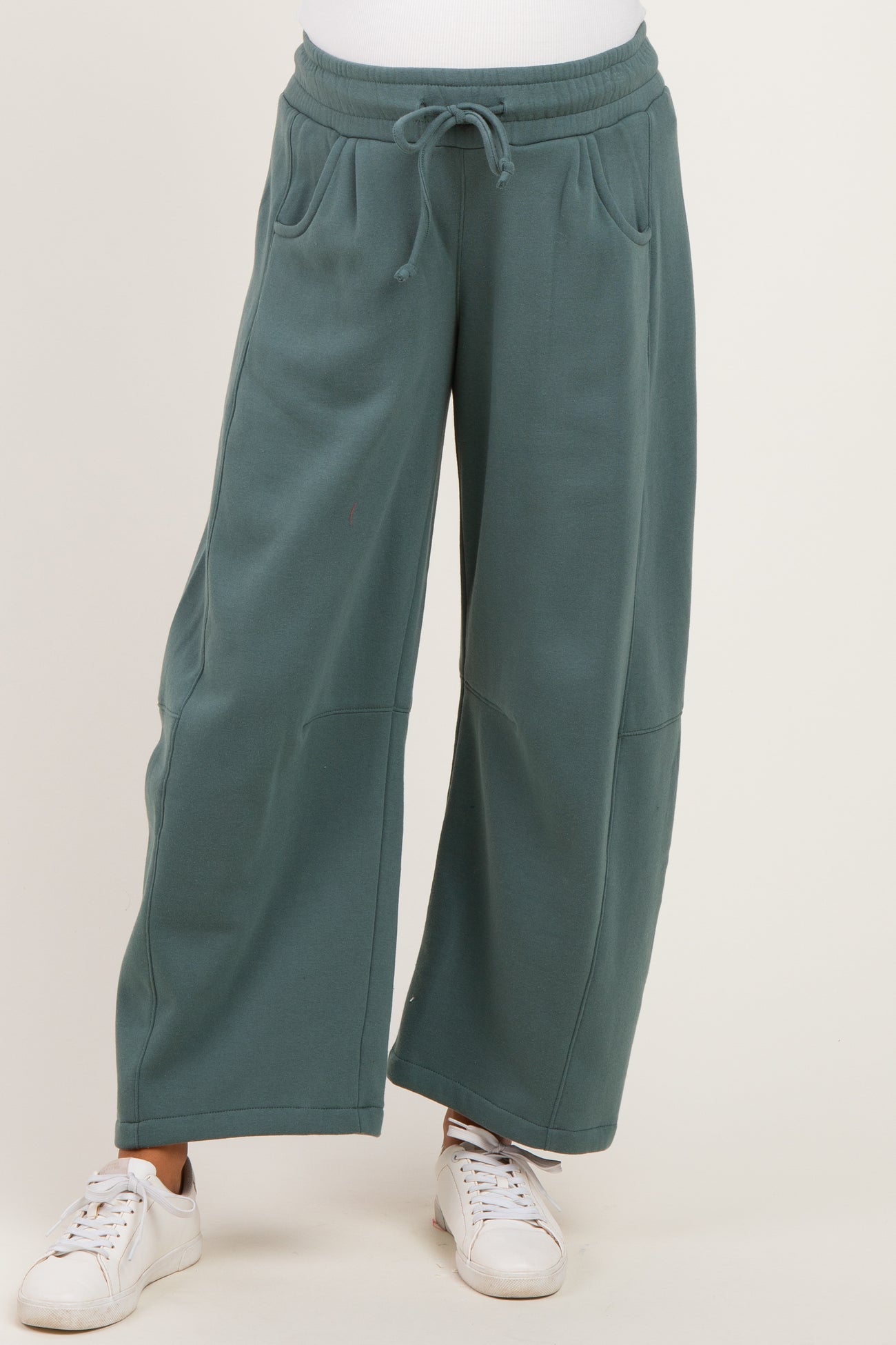 woman wearing teal wide-leg maternity sweatpants with pockets and drawstring waist