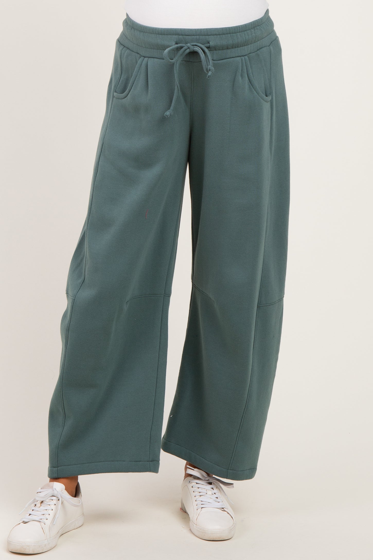 woman wearing teal wide-leg maternity sweatpants with pockets and drawstring waist