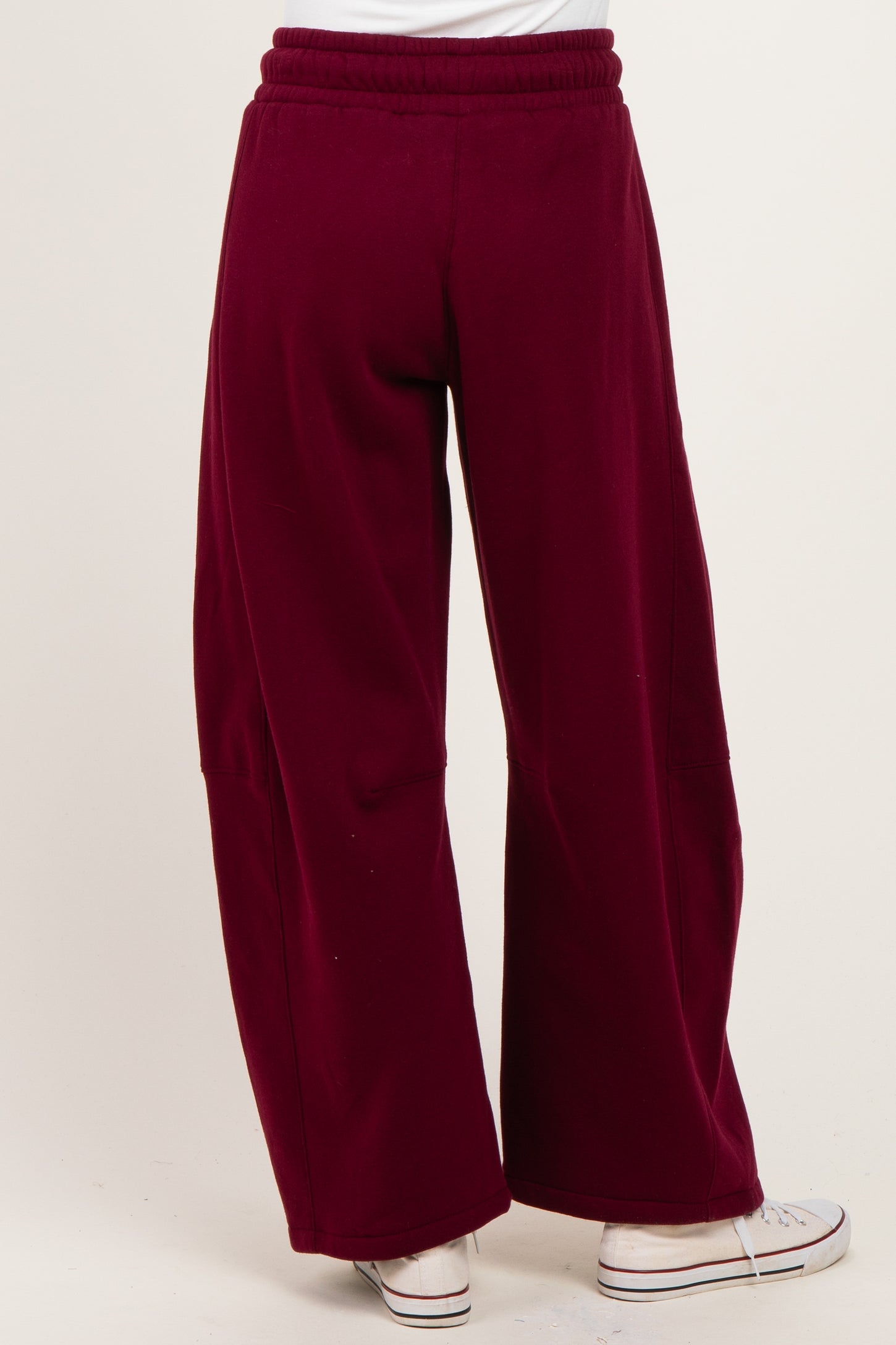 woman wearing burgundy wide-leg pants with an elastic waistband and back pockets