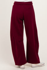 woman wearing burgundy wide-leg pants with an elastic waistband and back pockets