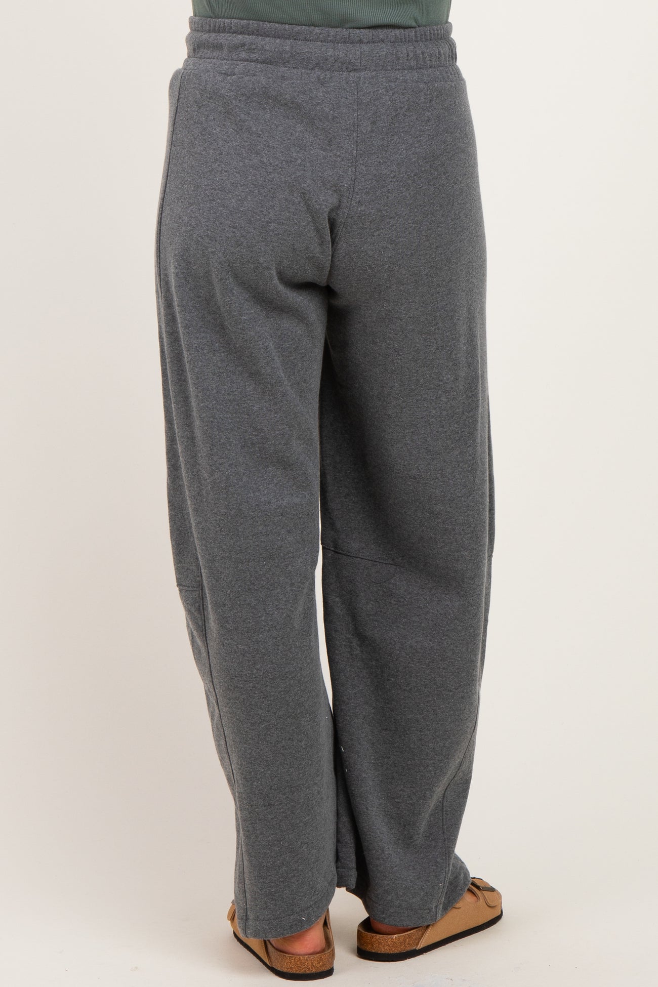 woman wearing gray maternity sweatpants, view of the back, relaxed fit and elastic waistband