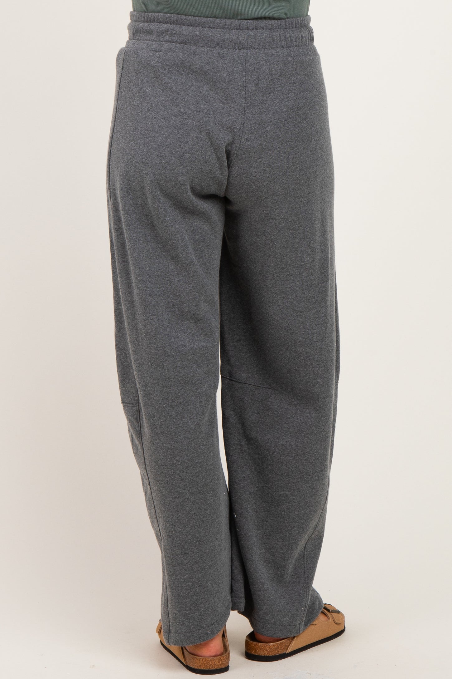 woman wearing gray maternity sweatpants, view of the back, relaxed fit and elastic waistband