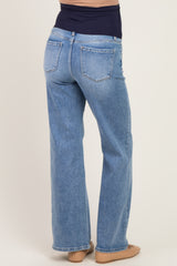 woman wearing light blue maternity jeans with a flared style, showing the back view and a supportive waistband