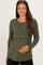 woman wearing an olive green long sleeve ribbed maternity top and holding her baby bump