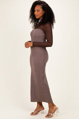 woman wearing a brown striped maxi dress with sheer long sleeves and clear heeled sandals