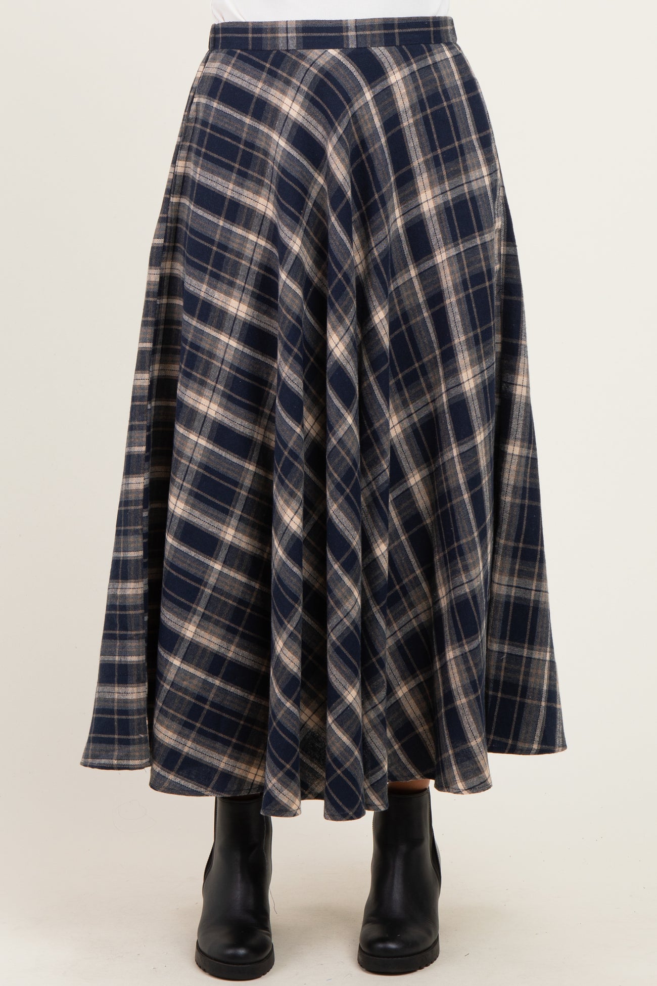 navy and cream plaid midi skirt with a flared silhouette, paired with black ankle boots