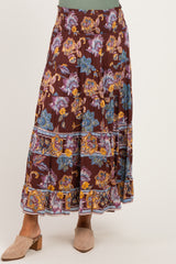 woman wearing a bohemian floral print maternity maxi skirt with an elastic waistband
