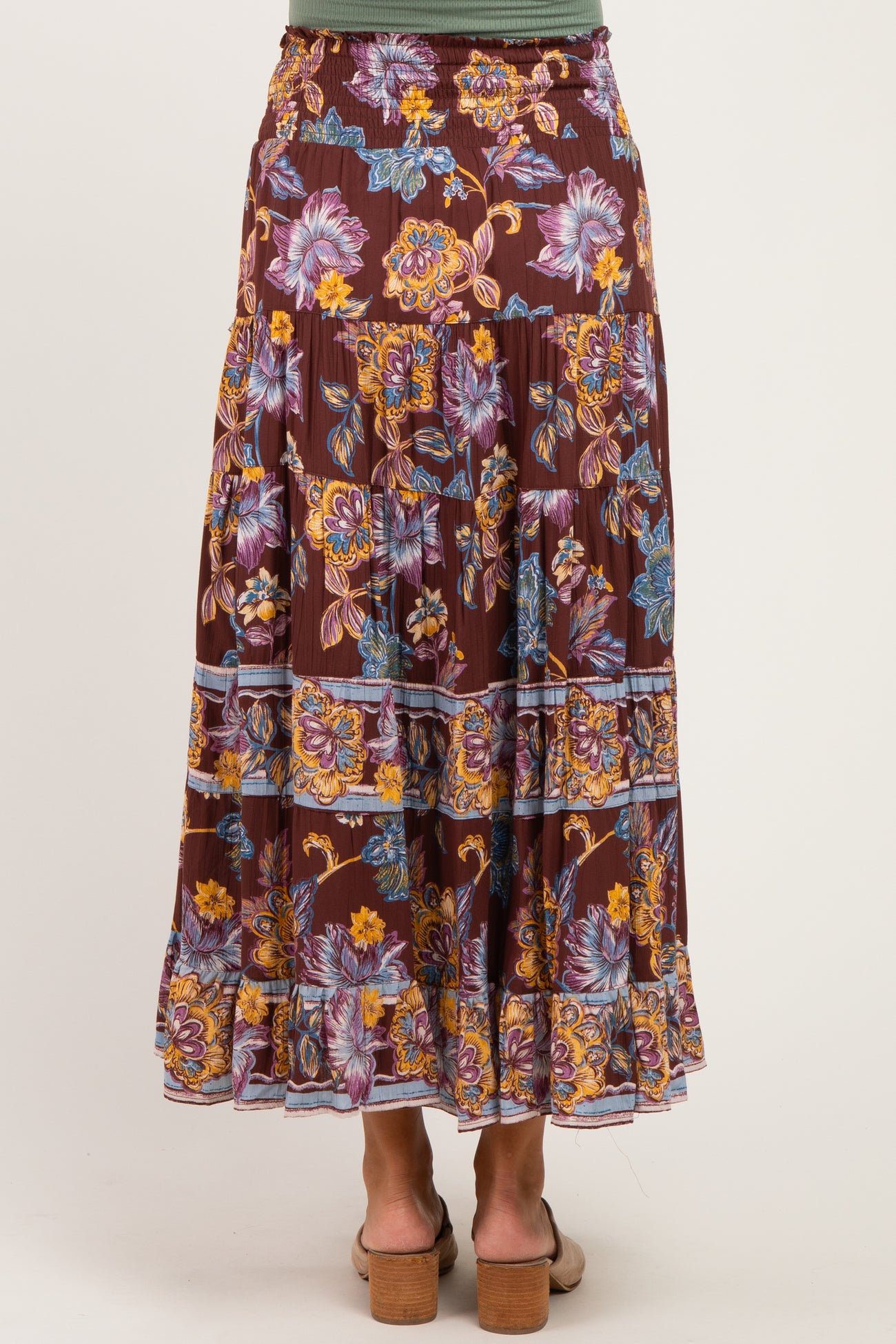 woman wearing a burgundy floral print maternity maxi skirt, standing with her back to the camera