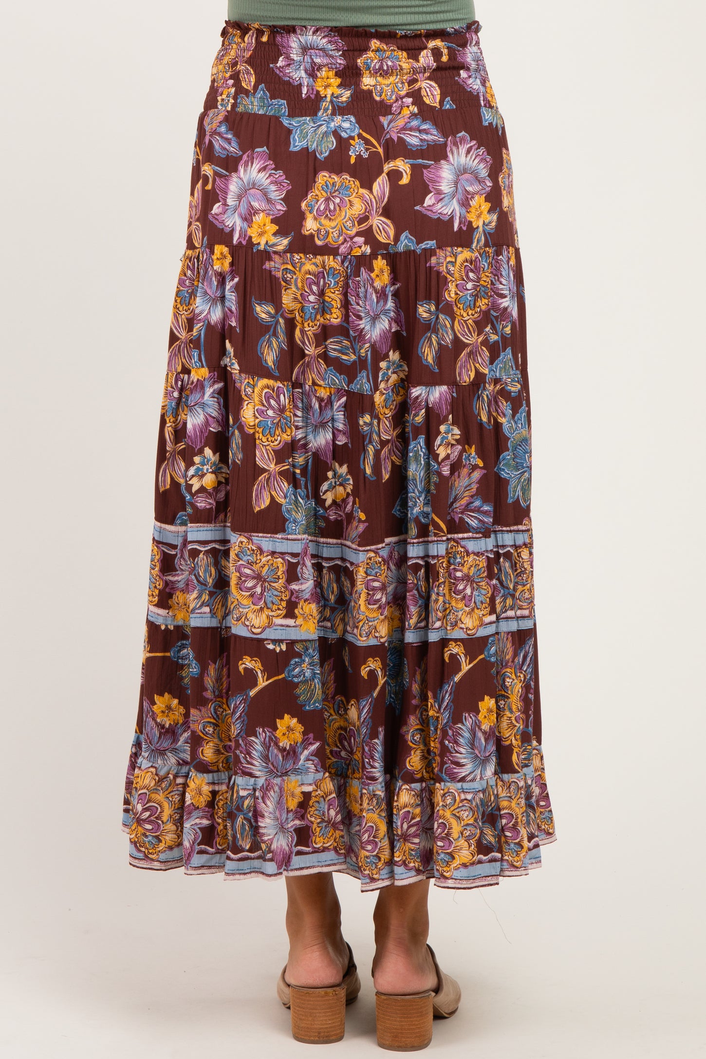 woman wearing a burgundy floral print maternity maxi skirt, standing with her back to the camera