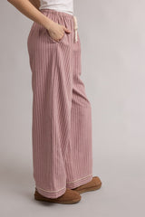 woman wearing pink striped wide-leg lounge pants with pockets and a drawstring waist