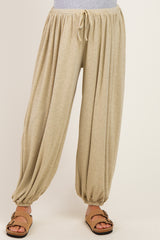maternity wear beige striped harem pants with an elastic waistband and cuffs, styled with a casual top and sandals