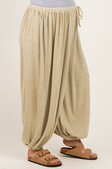 woman wearing beige striped maternity harem pants with an elastic waistband and gathered cuffs