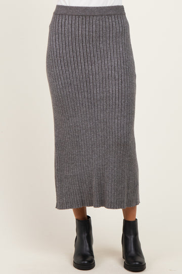 woman wearing a gray ribbed knitted midi skirt paired with black ankle boots