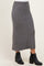 woman wearing a gray ribbed midi skirt with a fitted waistband and side slits, paired with black ankle boots