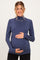 woman wearing a navy ribbed long sleeve maternity top and holding her baby bump