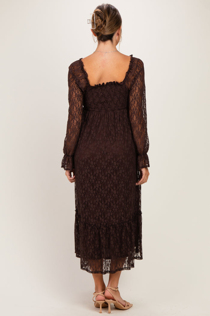woman wearing a brown lace maternity dress with long sleeves and a ruffled hem, showing her baby bump from the back