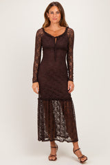 woman wearing a brown lace long sleeve maxi dress with a ruffled hem and a fitted bodice