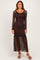 woman wearing a brown lace long sleeve maxi dress with a ruffled hem and a fitted bodice