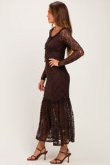 woman wearing a brown lace long sleeve maxi dress with a ruffled hem and a fitted bodice