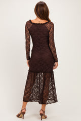 woman wearing a brown lace long sleeve midi dress with a tiered hem and a fitted silhouette