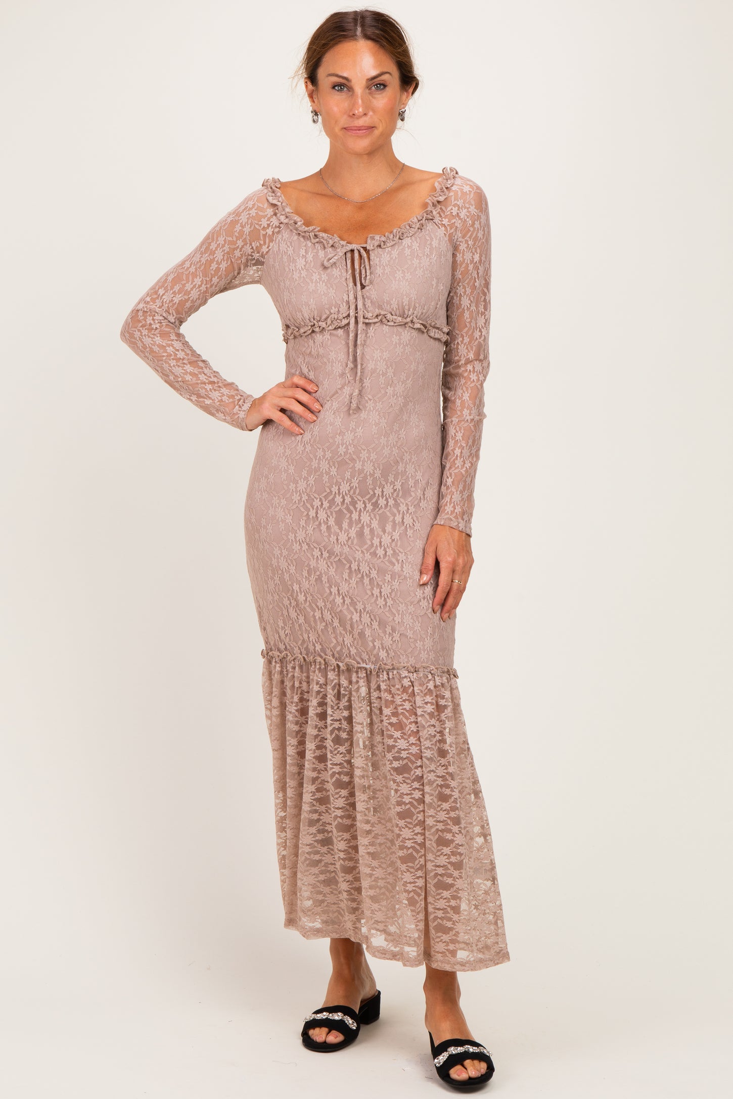 woman wearing a mauve long sleeve lace maxi dress with ruffle hem and drawstring detail at the waist