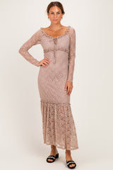 woman wearing a mauve long sleeve lace maxi dress with ruffle hem and drawstring detail at the waist